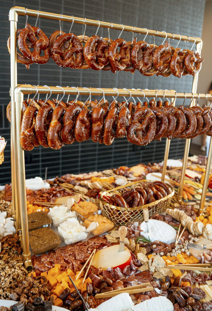 Grazing table with hanging pretzels on a stand