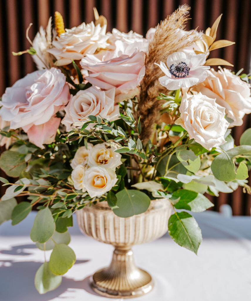 DIY Wedding Flowers in a gold compote vase.