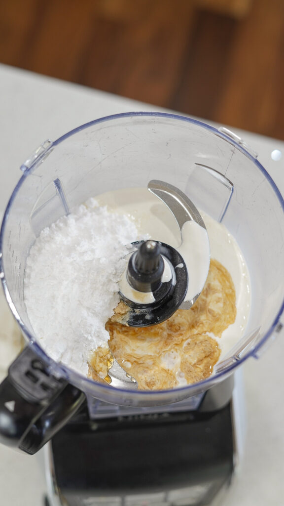 Sugar free whipped cream recipe ingredients in a food processor.