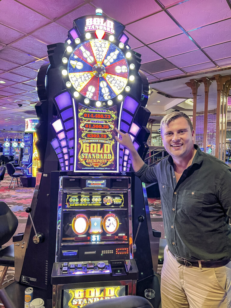 Man next to a winning slot machine at a lake tahoe casino.