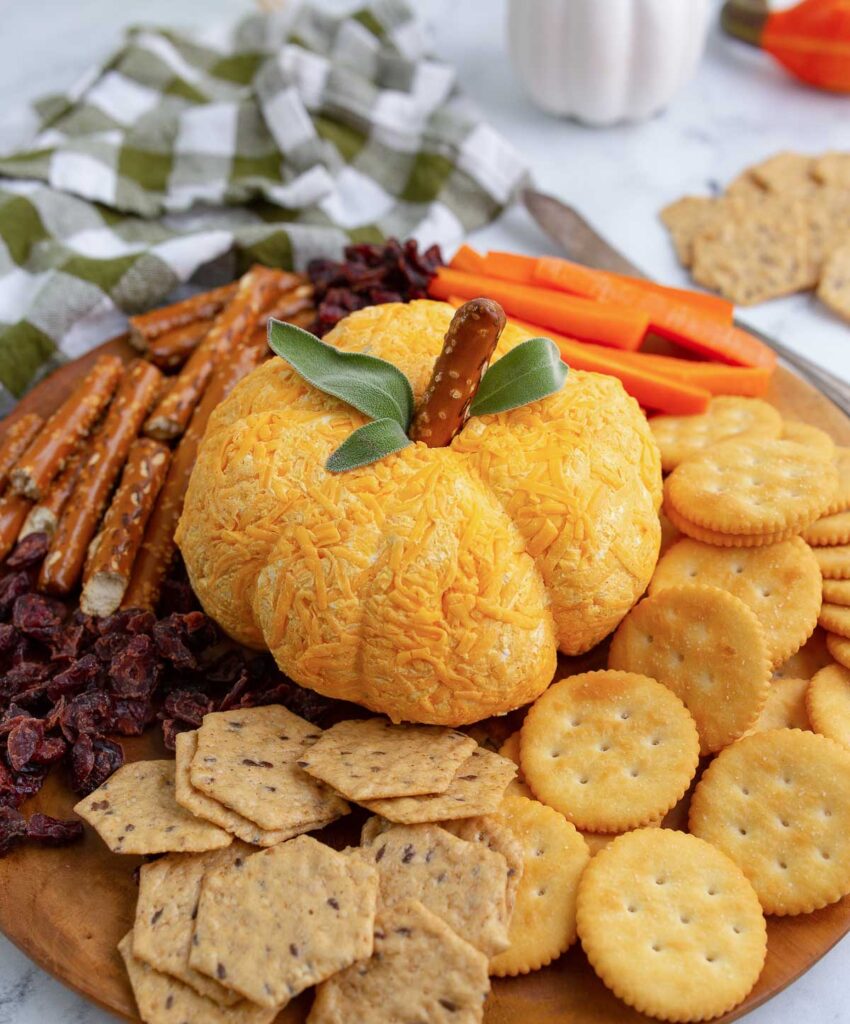 Pumpkin shaped cheese ball.