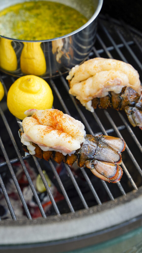 Lobster tails cooking on the grill.