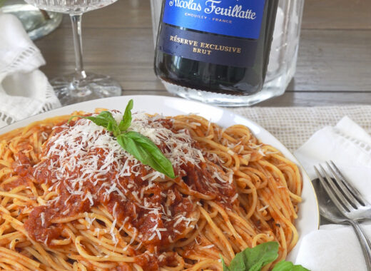 Champagne with pasta and red sauce.