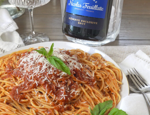 Champagne with pasta and red sauce.