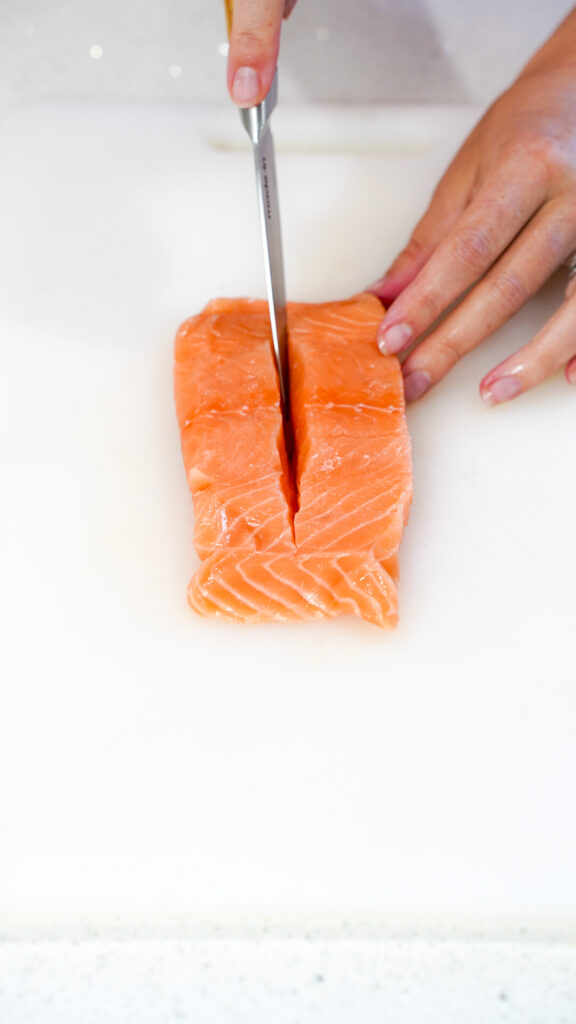 Slicing a salmon filet for a crab stuffed salmon recipe.