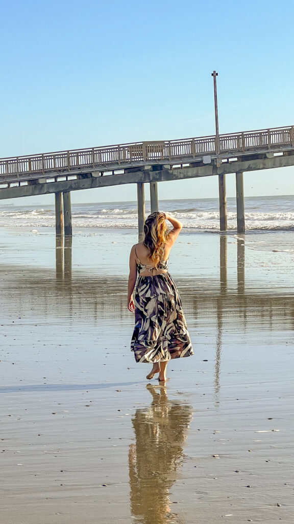 Woman walking on the shore of Myrtle Beach.