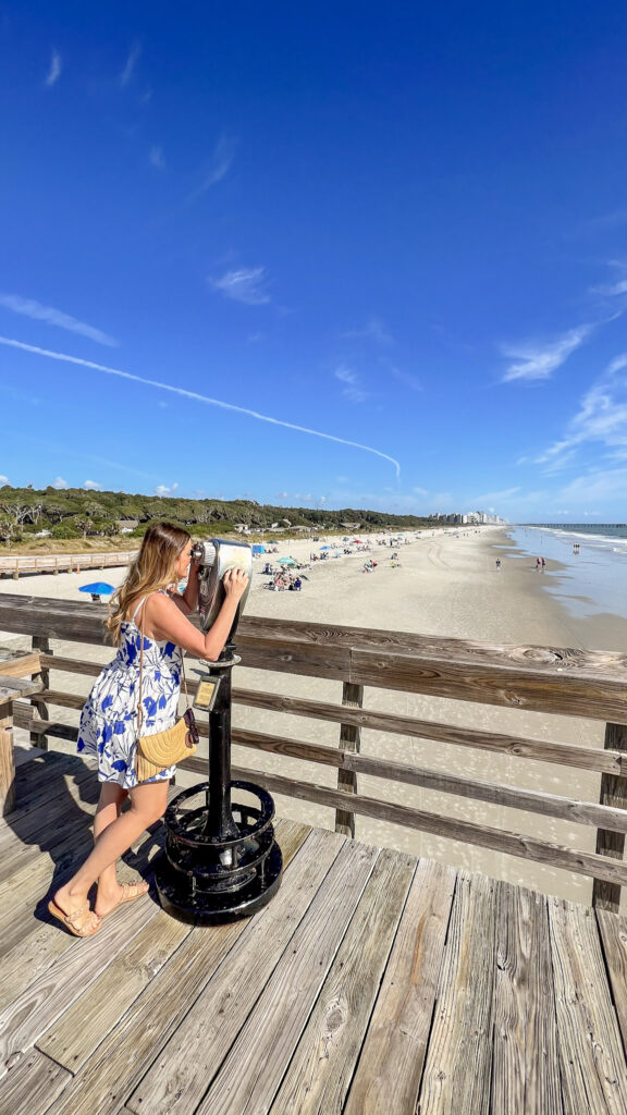 Karen looking through a looky loo on the boardwalk in Myrtle Beach in the fall. 