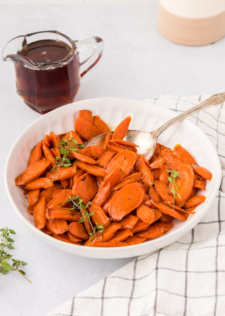 Maples roasted carrots in a bowl.