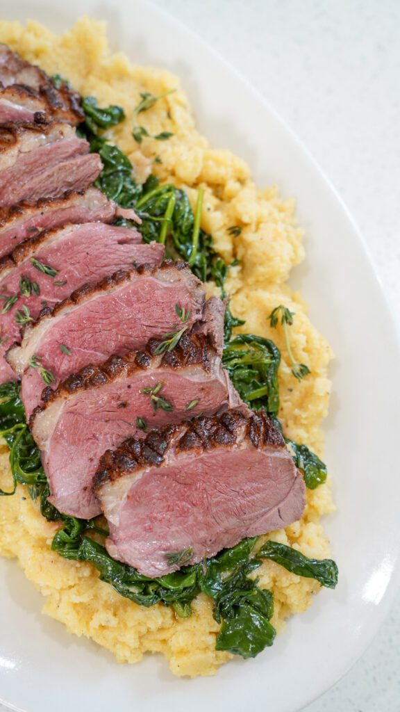 Parmesan polenta side dish served with duck breast.