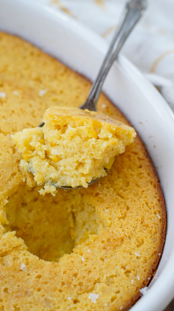 Southern corn casserole with a spoon.
