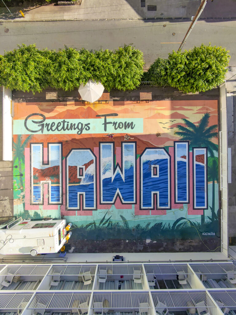Mural that says Greetings from Hawaii at 'Alohalani resort in Oahu, Hawaii.