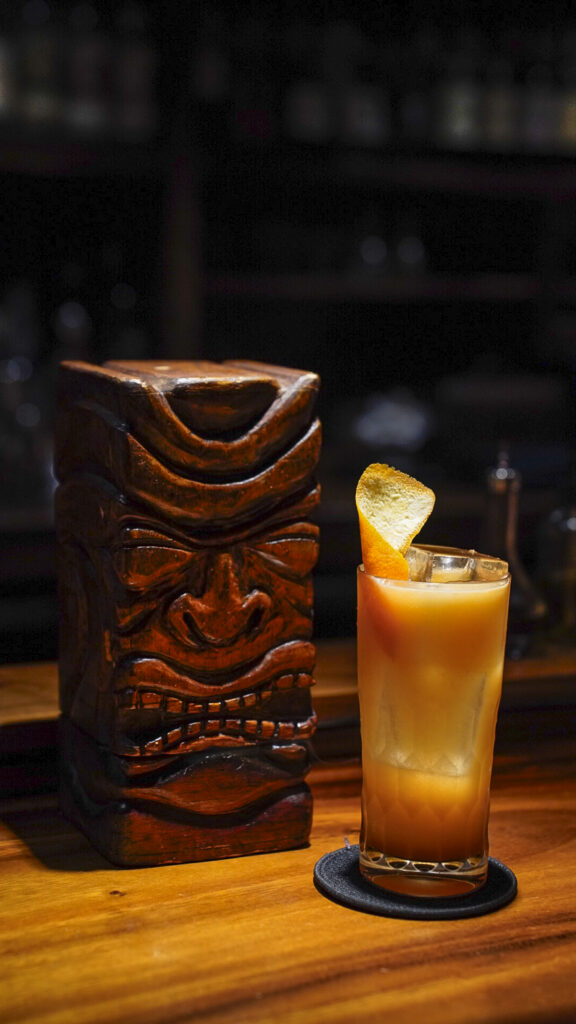 Tiki drink at bar leather apron, a romantic thing to do in Oahu, Hawaii.