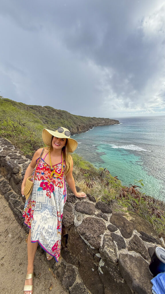 Woman walking down to the beach of Hanauma Bay in Oahu, Hawaii.