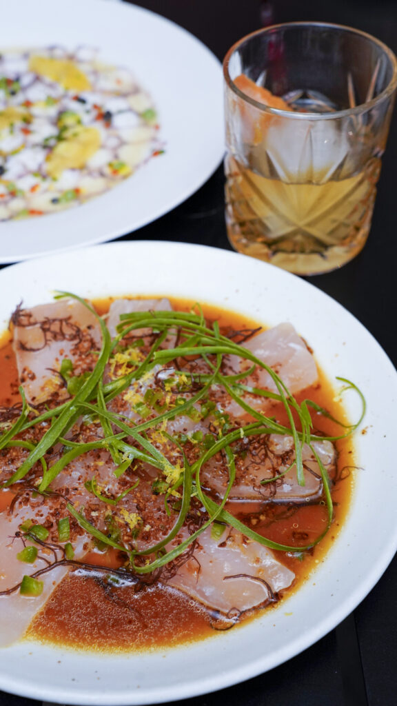 Cocktail and carpaccio from a bar in Oahu, Hawaii.
