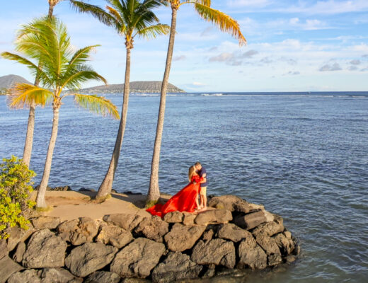Couple hugging on the shore, romantic things to do in Oahu, Hawaii.