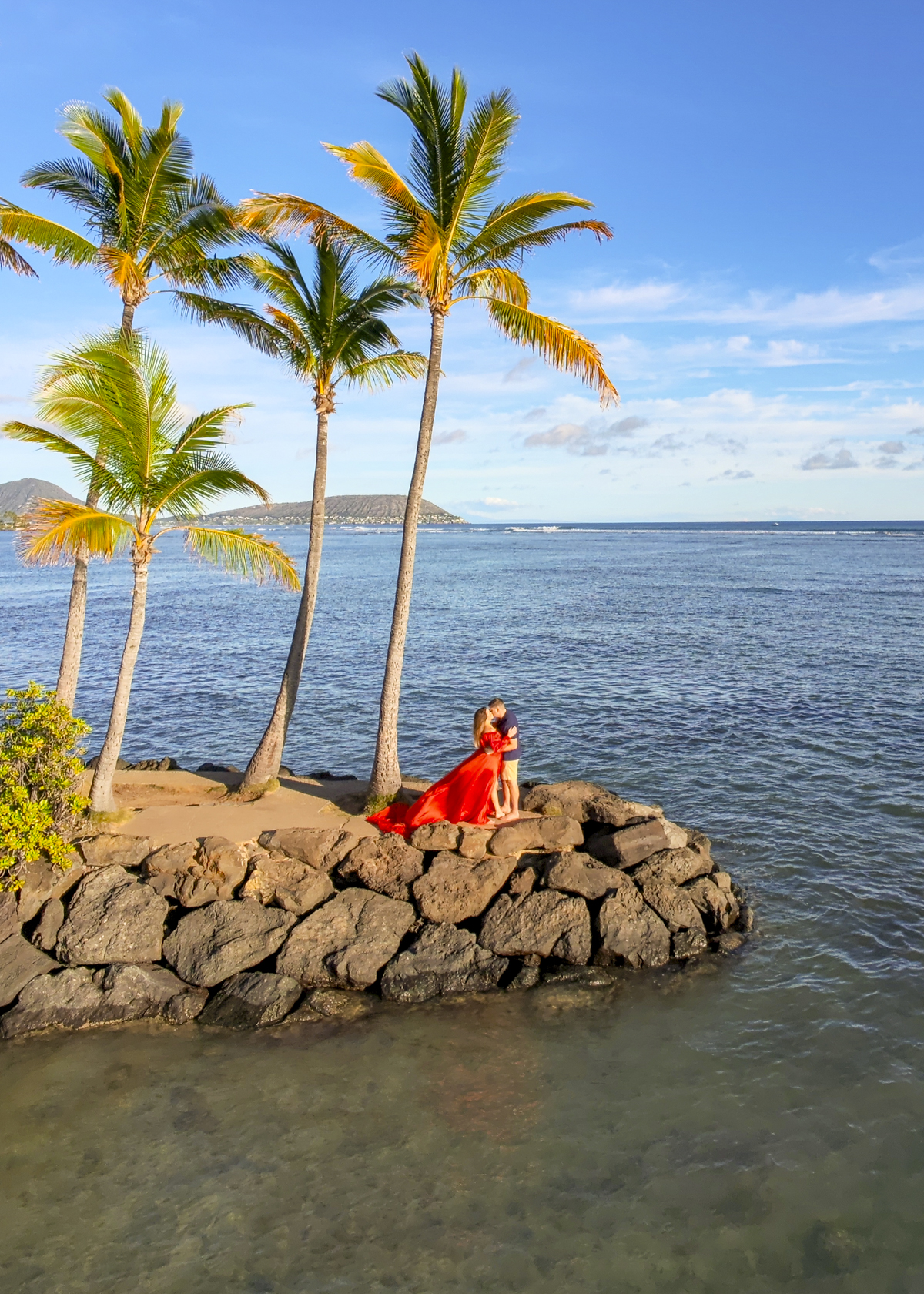 Couple hugging on the shore, romantic things to do in Oahu, Hawaii.