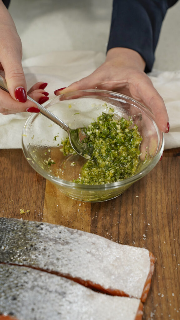 Preparing a marinade for a tasty baked Mediterranean salmon recipe.