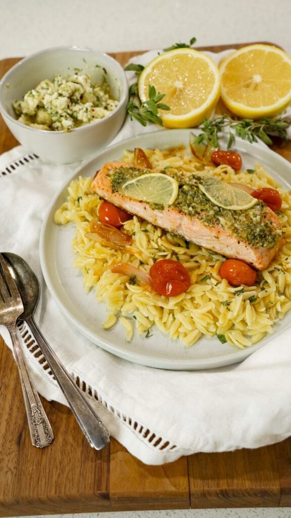 An easy baked Mediterranean salmon recipe topped with flavorful marinated feta on a plate.