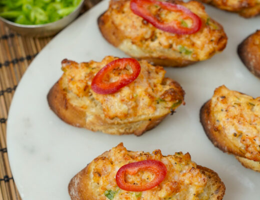 Vietnamese Shrimp Toast - Banh Mi Chien Tom on a platter with a pepper on top.