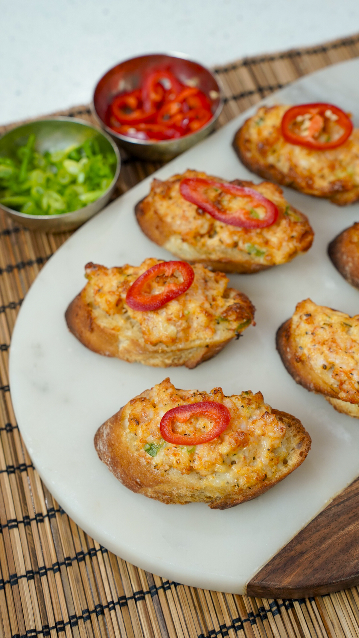 Vietnamese Shrimp Toast - Banh Mi Chien Tom on a platter with a pepper on top.