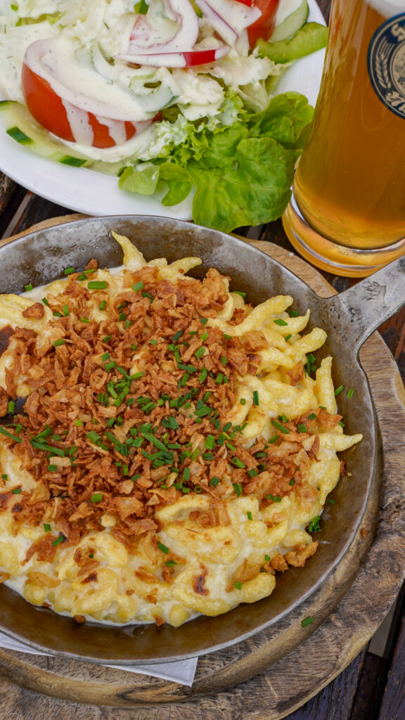 Take with salad, beer and cheesy spaetzle in Nuremberg, Germany.