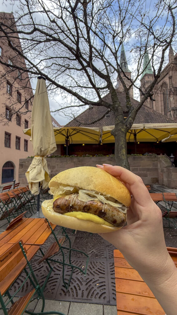 Holding a brat in a bun in Nuremberg, Germany.