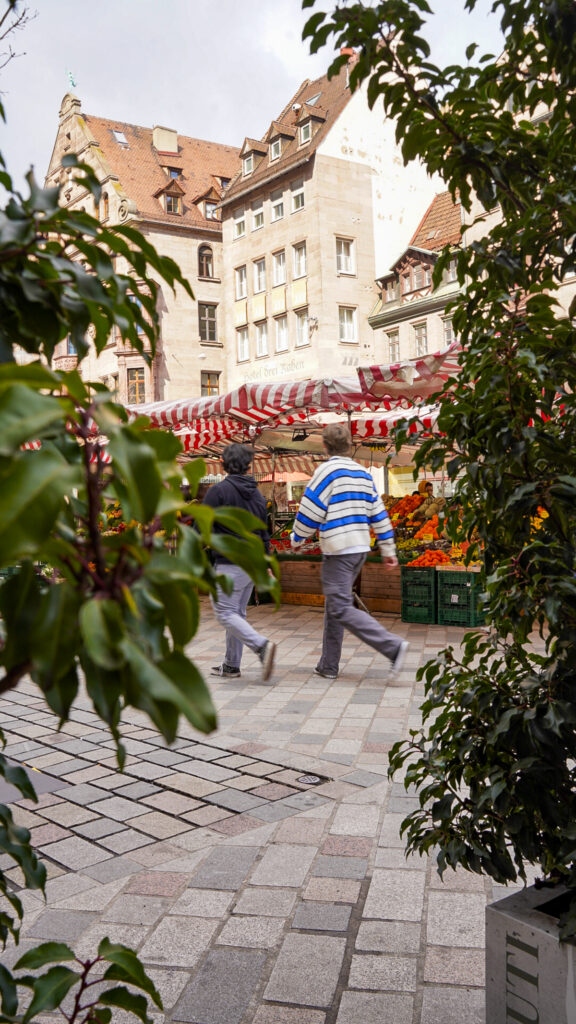 People walking at an outdoor market outside one of the besr restaurants in Nuremberg, Germany.