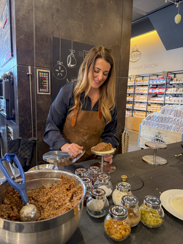 Woman cooking gingerbread cookies in Nuremberg, Germany.