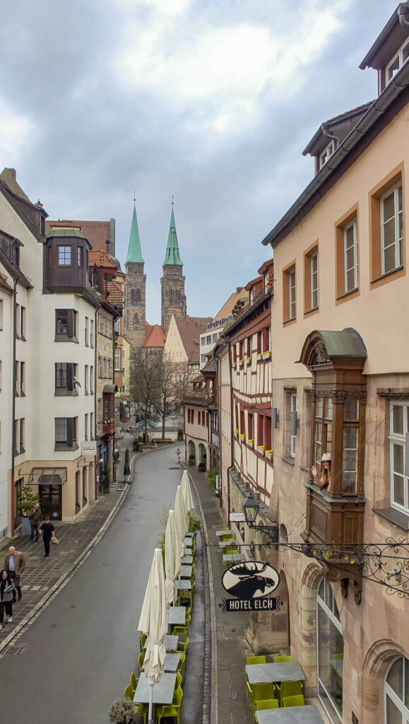 Woman in a window outside of Hotel Elch in Nuremberg, Germany.