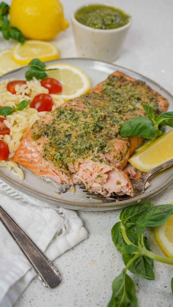 A fork with a piece of grilled pesto salmon recipe.