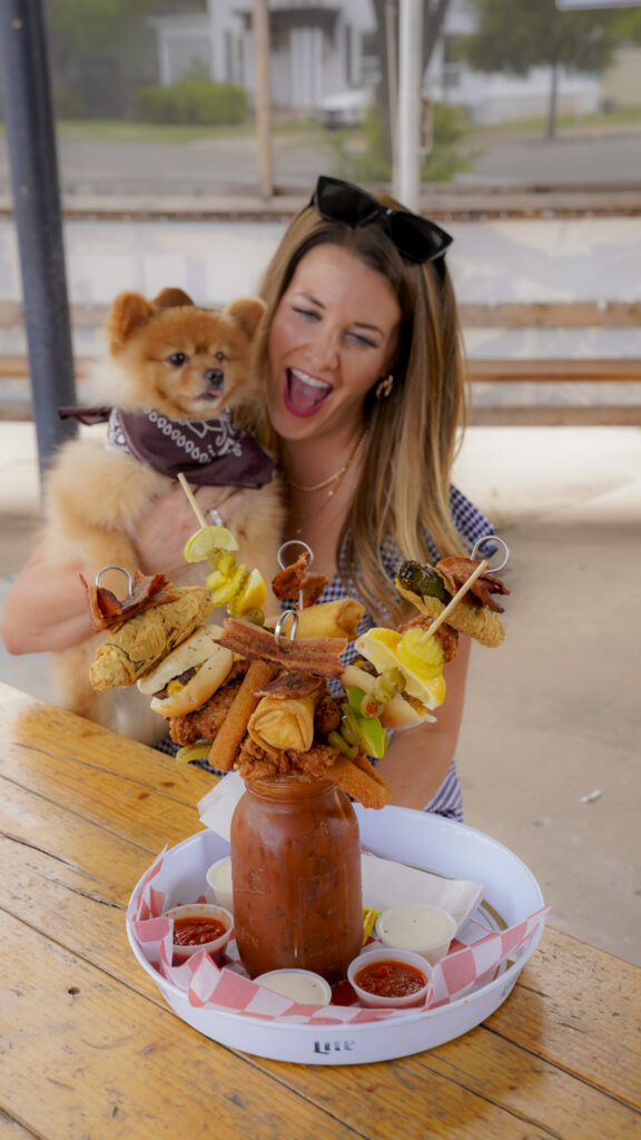 Woman and a dog with a loaded bloody mary in Amarillo, Texas.