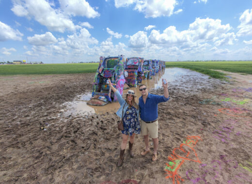 Couple with spray paint aat Cadillac Ranch - one of the most unique things to do in Amarillo, Texas.