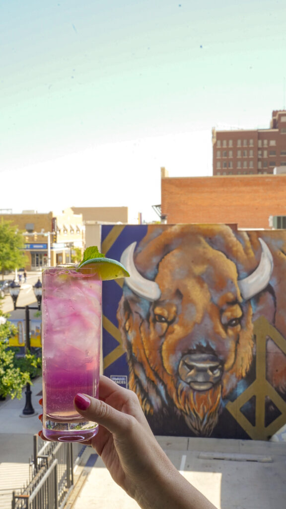 Cocktail in front of a mural in Amarillo, Texas.