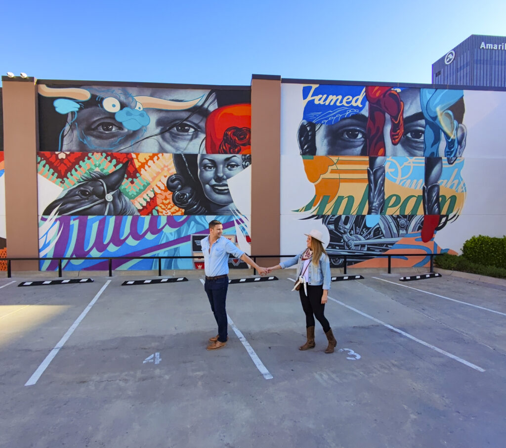 Couple outside of a mural in Amarillo, Texas.