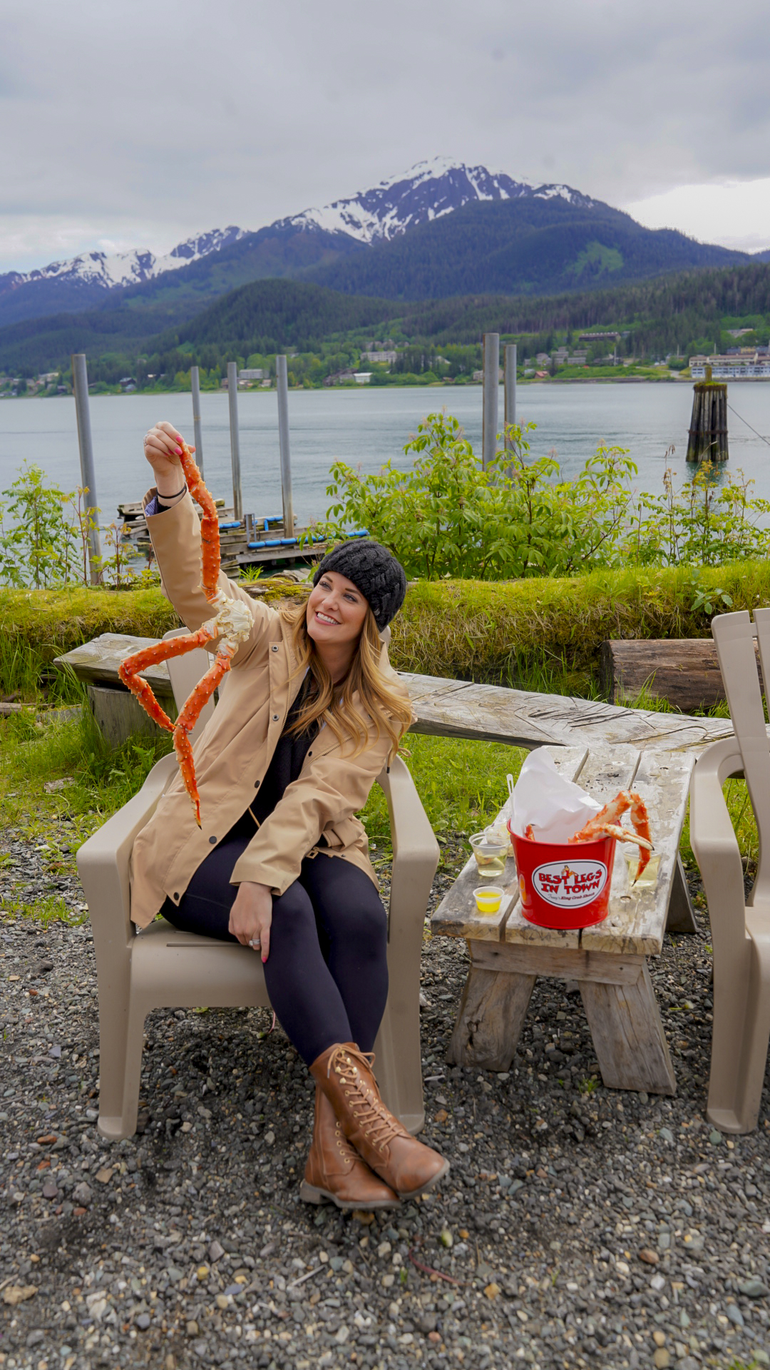 Woman holding a crab leg from Tracy's Crab Shack in Juneau, Alaska.