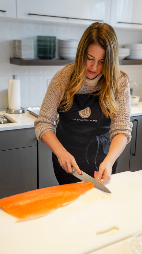 Woman taking a cooking class at the Jorgensen House in Juneau, Alaska.