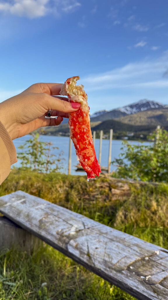 Woman holding crab at Tracy's Crab Shack, one of the best things to do in Juneau, Alaska.