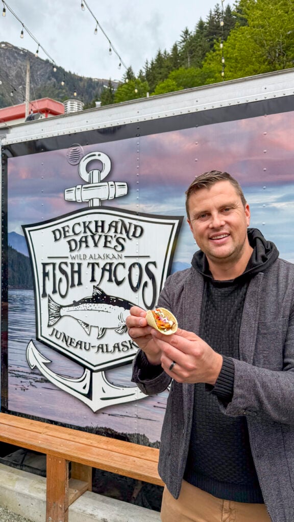Man holding a taco at Deckhard Daves, one of the best places to eat in Juneau, Alaska.