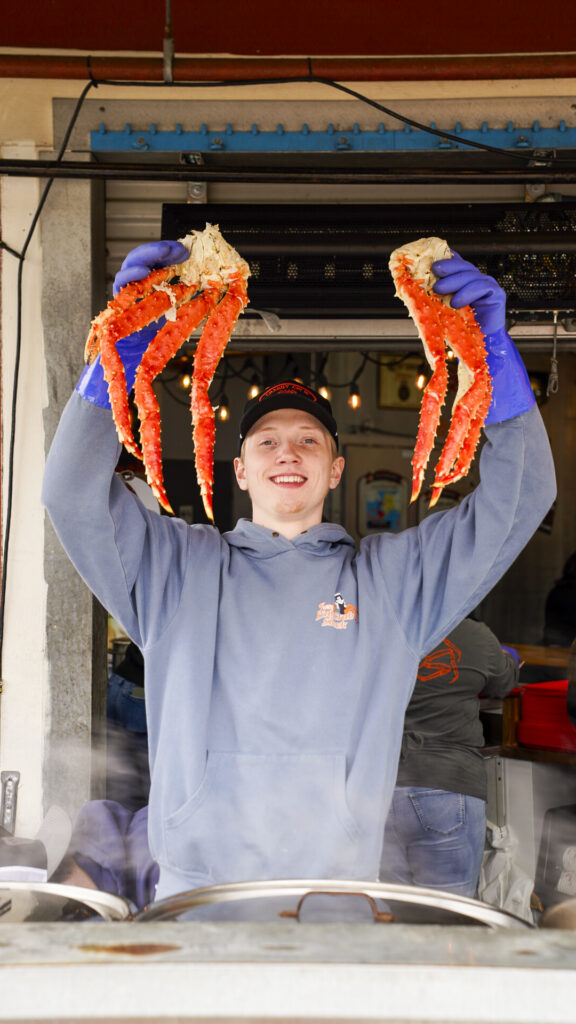 Man holdng crab at Tracy's Crab Shack, one of the best things to do in Juneau, Alaska.