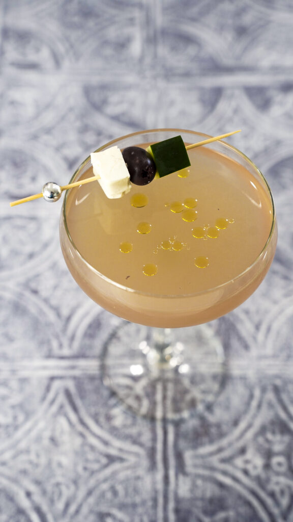 Greek Salad Cocktail Clumsies Mediterranean Gimlet Recipe in a couple glass.