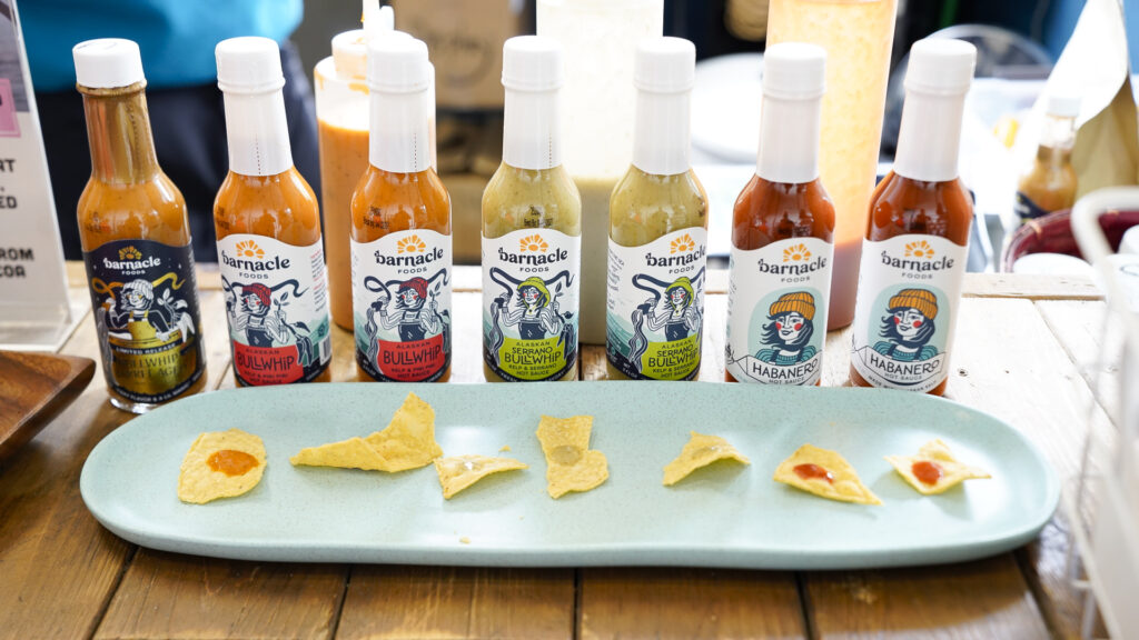 Sampling barnicle foods sauces, one of the best things to eat in Juneau, Alaska.