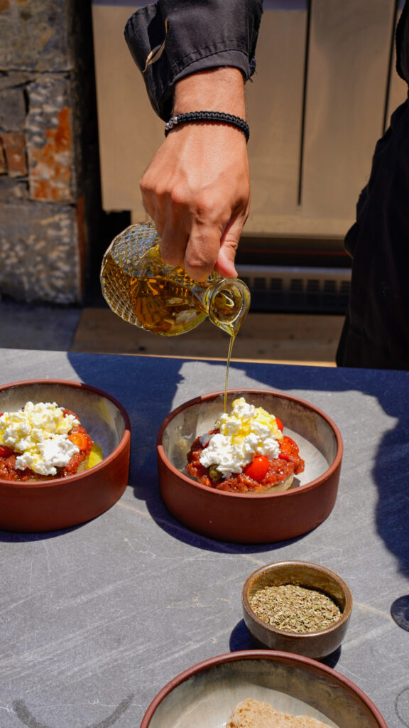 Man making dakos at a cooking class at Abaton resort in Crete.