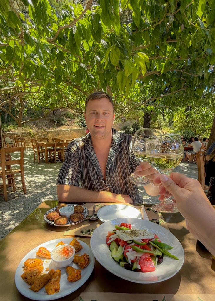 Man with wine at Gefyra restaurant near Rethymno Crete.