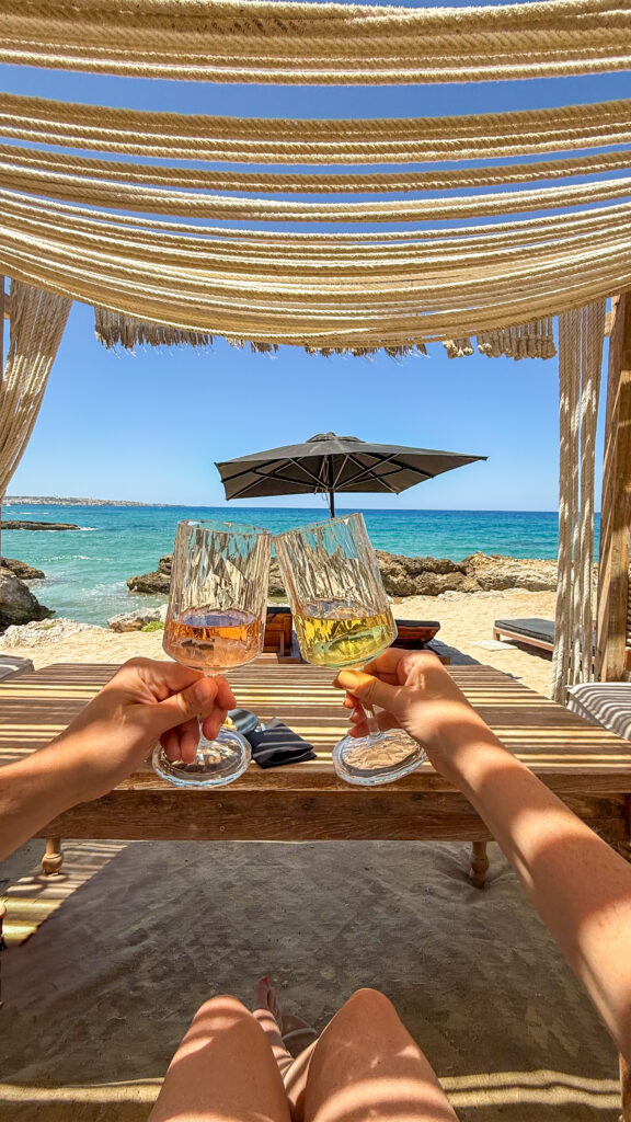 Couple with drinks inside a cabana at Abaton resort in Crete.