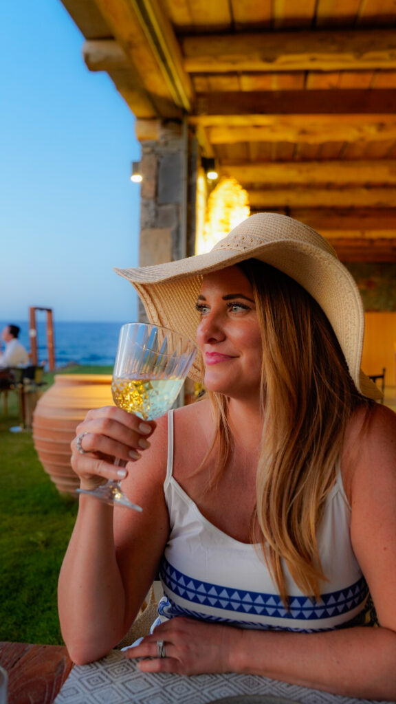 Woman with a glass of wine in Crete.