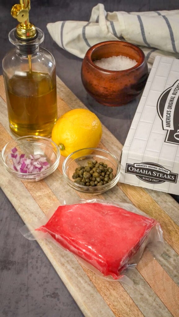 Sicilian sashimi tuna carpaccio recipe ingredients on a board.
