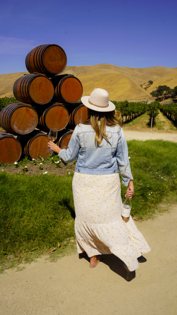 Woman holding a glass of wine at a Livermore winery.