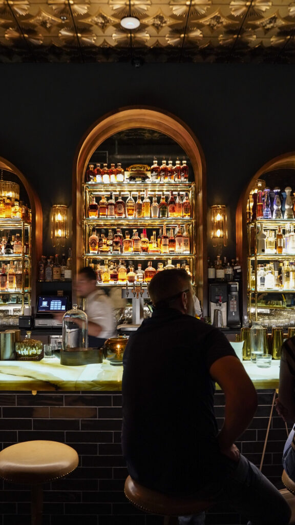 Bartender pouring a cocktail at a Livermore speakeasy.