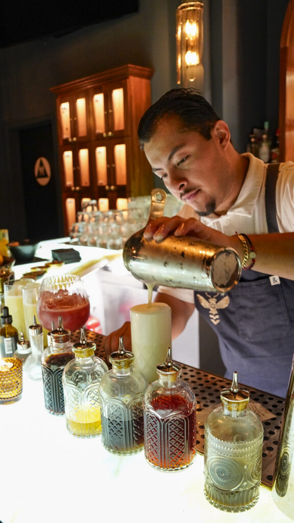 Bartender pouring a cocktail at a Livermore speakeasy.