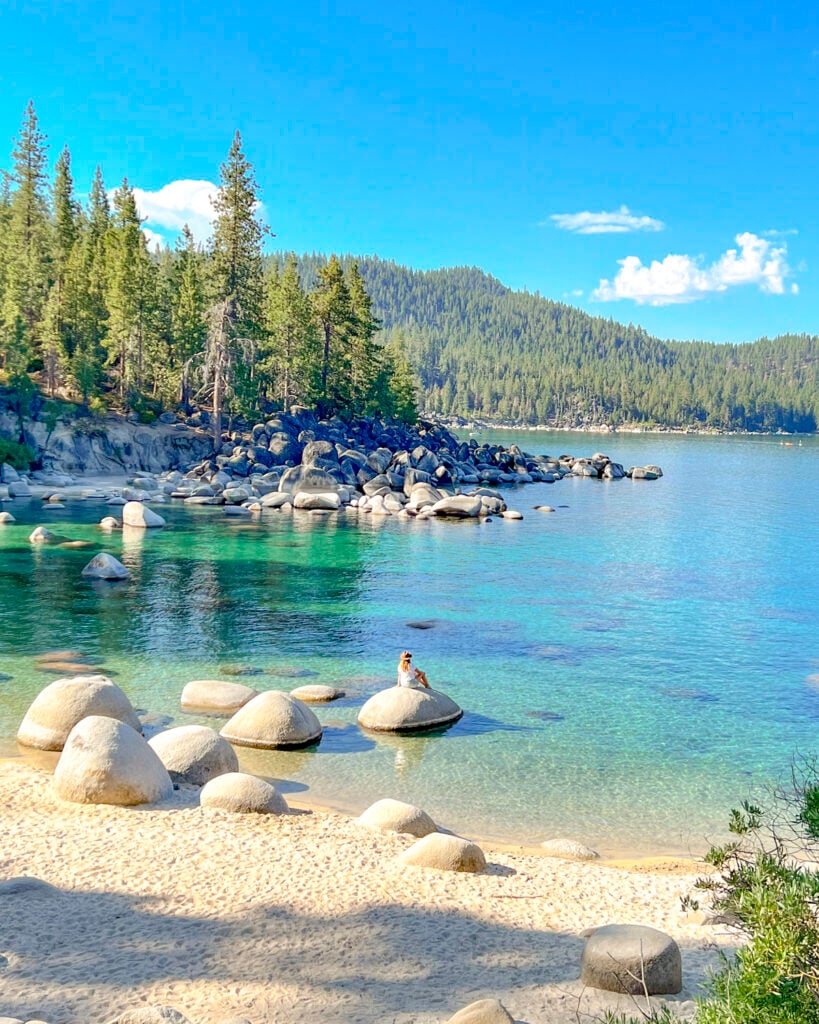 Woman on a rock in secret cove at Lake Tahoe.